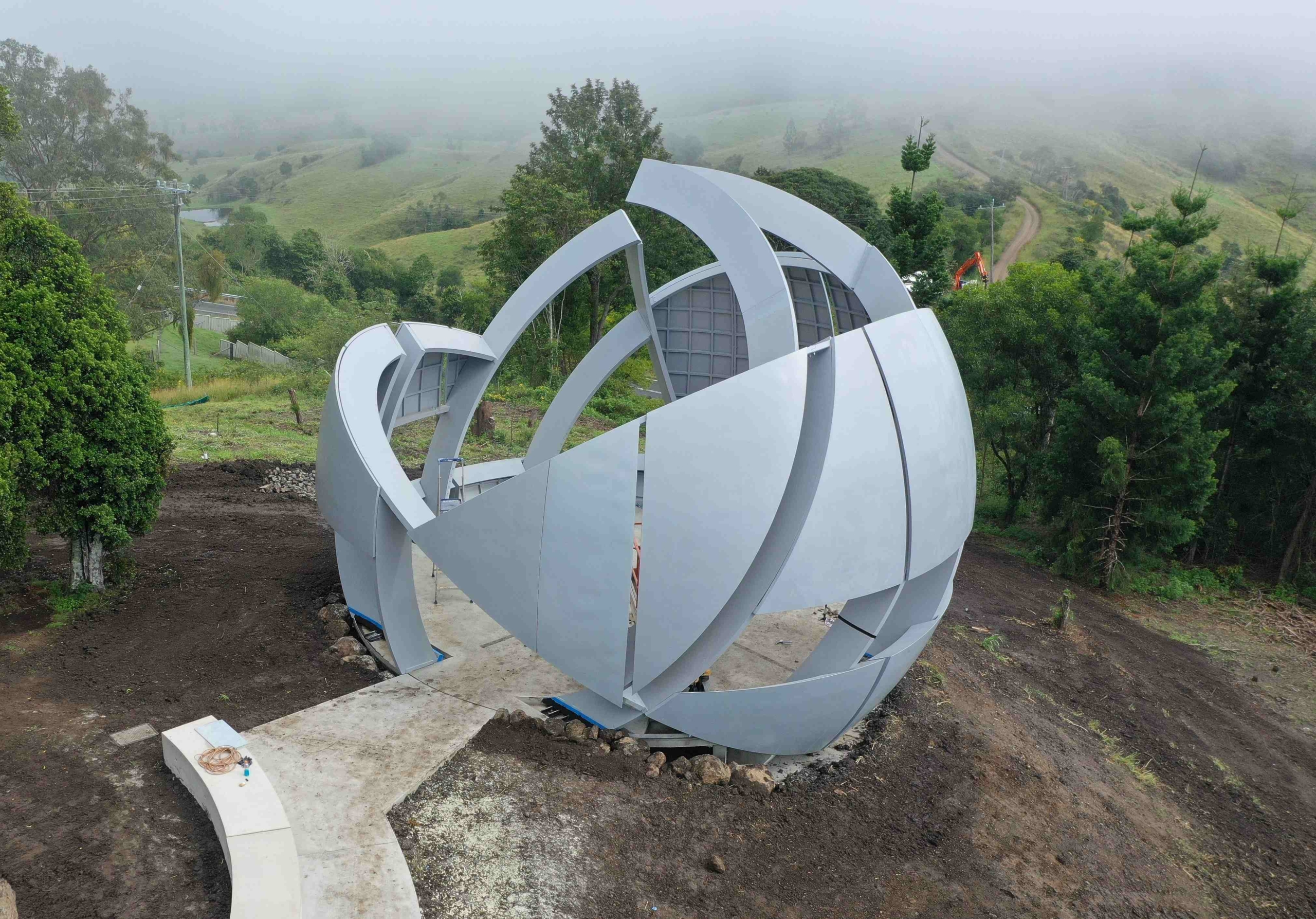 Photograph of the completed steel structure in the landscape.