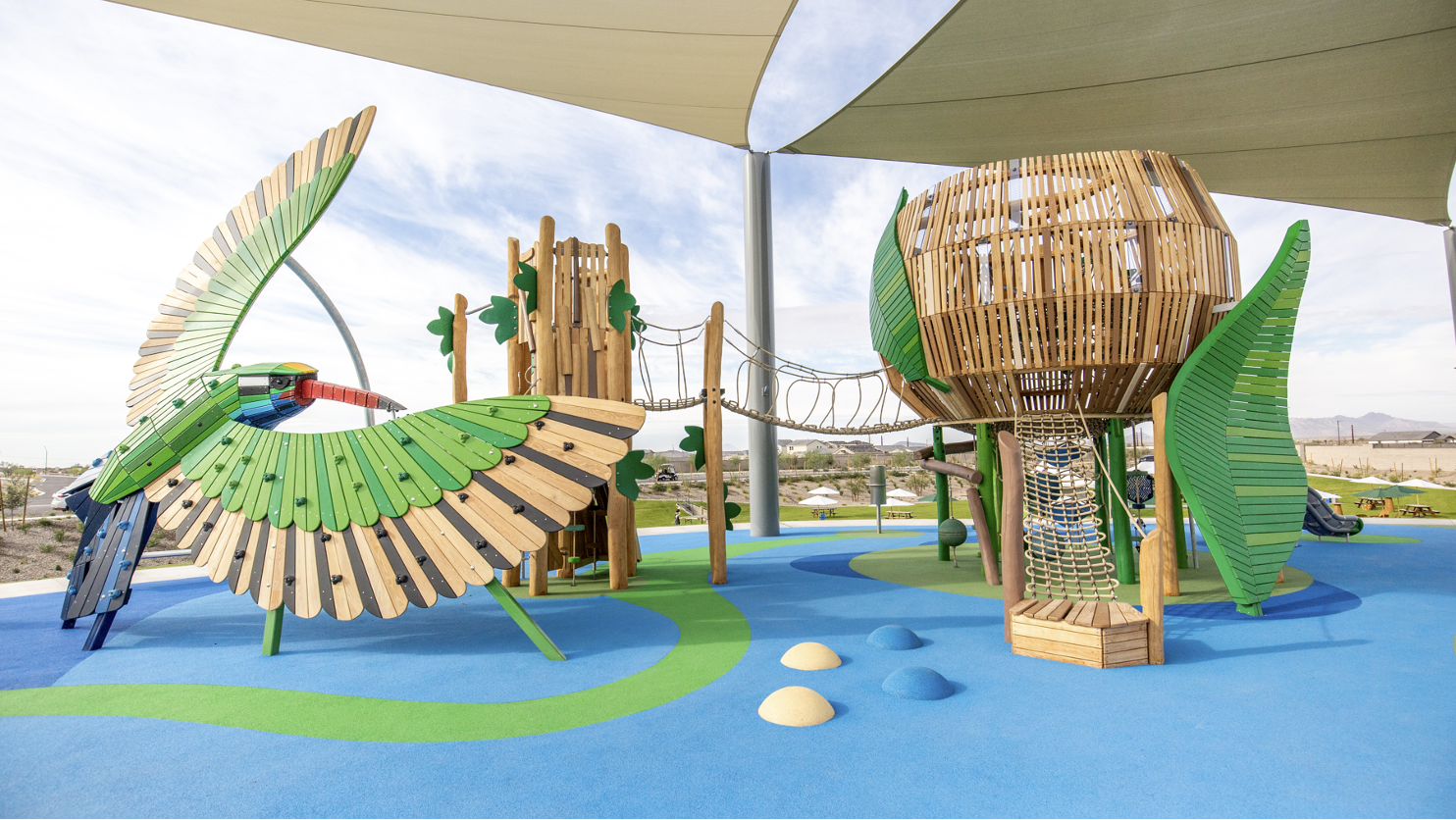Installed playground with bird and nest-inspired play structures.
