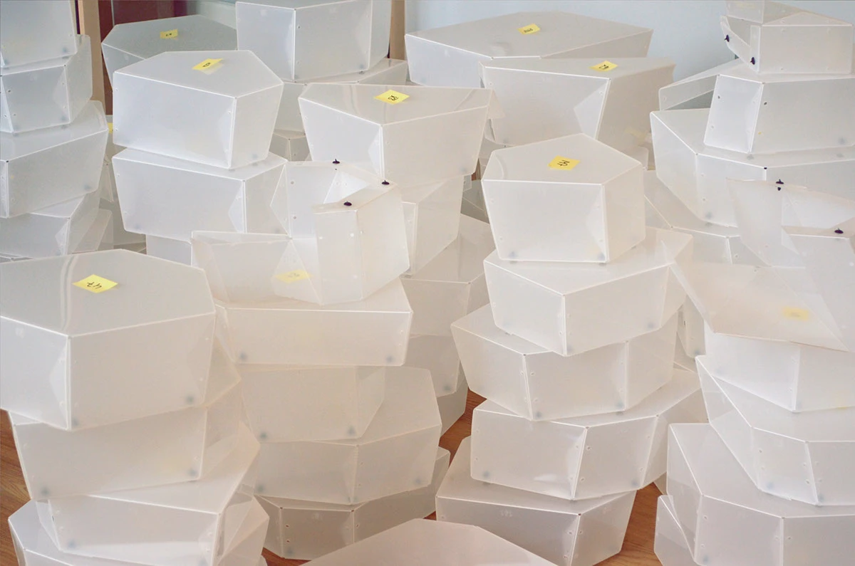 Stacks of folded and numbered polypropylene modules before assembly.