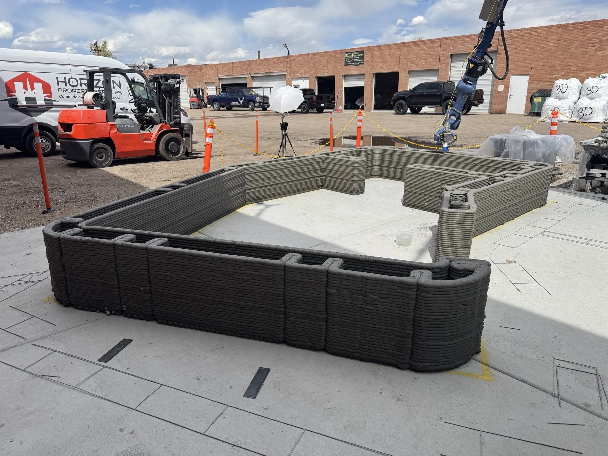 RCT robot above concrete walls during an early print test.